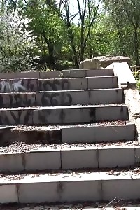Black-haired Doll Pisses Down Some Concrete Steps