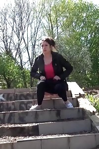 Black-haired Doll Pisses Down Some Concrete Steps