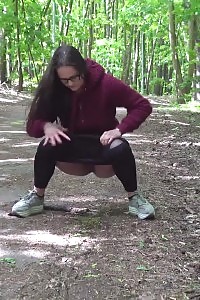 Good-looking Black Haired Girl Squats And Pees Outside