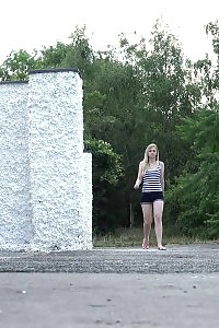Sweetie Pisses Behind A White Wall Outside