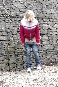 Blonde In Jeans Denim Pisses Outdoor In The Wind