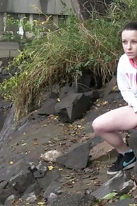 Brunette Bitch Pisses Next To A Flowing River