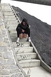Kinky Black Haired Doll In Glasses Pissing Outside