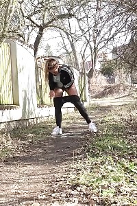 Naomi Benet Taking A Leek Near Abandoned Building