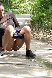 Good-looking Black Haired Chicks Pee Together Outdoor