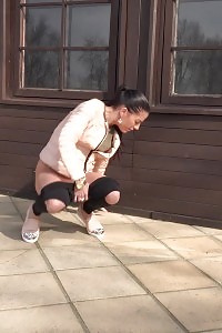 Black Haired Chick Squats To Pee Outside
