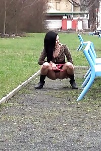 Filthy Black-haired Slut Pissing In A Public Park
