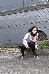 Brunette Lady Pisses By A Public Car Park