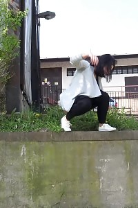 Black Haired Gal Sprinkles Her Pee Off A Ledge