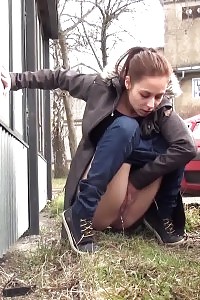 Outstanding Brunette Doll Pisses Behind A Schoolbus Stop