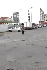 Big-breasted Brunette Taking A Leek Behind A Bus