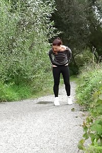 Attractive European Squatting To Piss On A Path