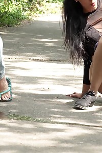 Good-looking Black Haired Chicks Pee Together Outdoor
