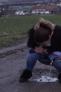Black Haired Chick In Denims Pees Outside