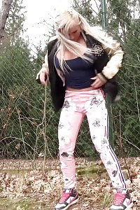 Fearful Looking Light-haired Squats To Pee While Outside
